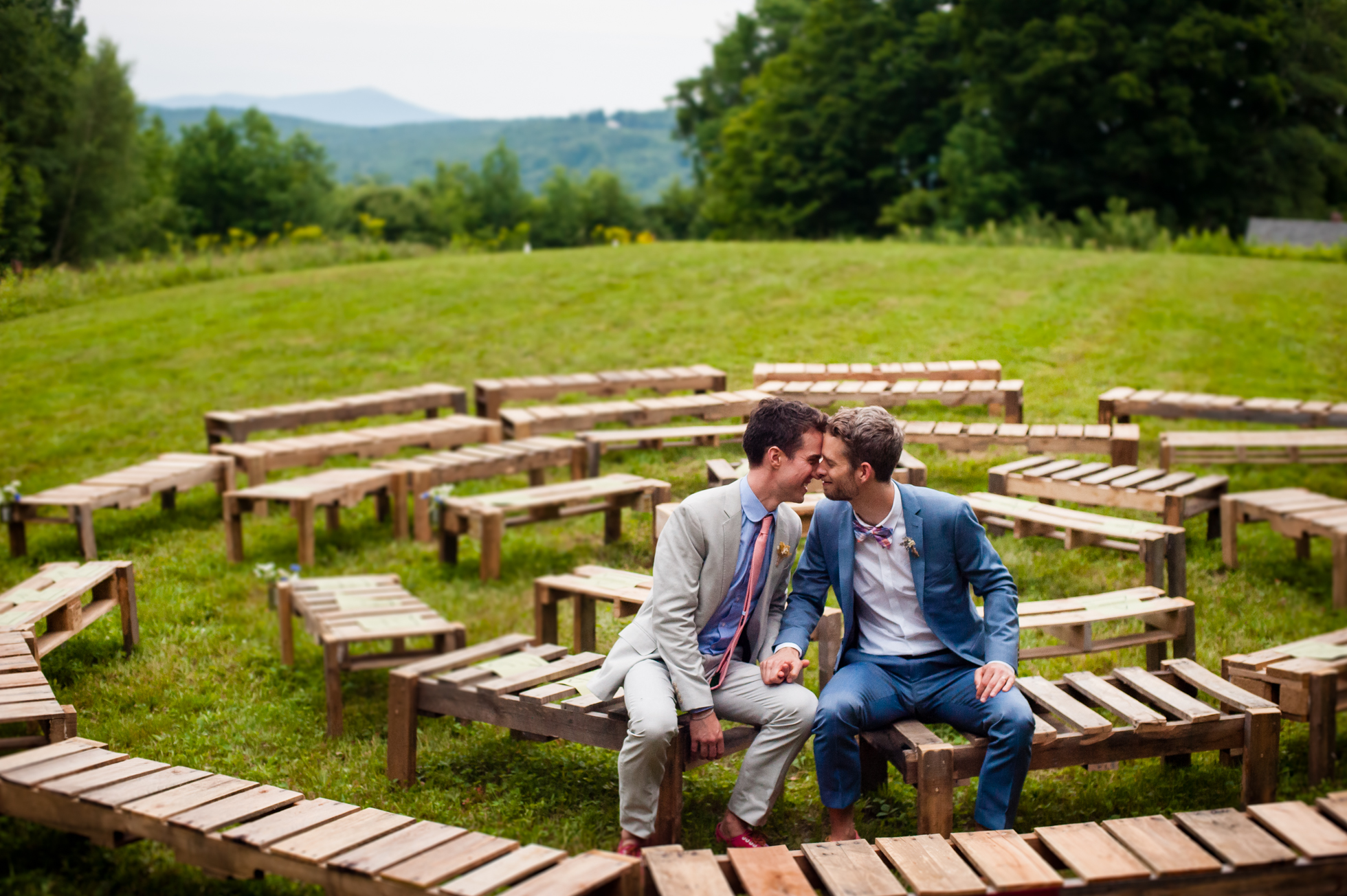 two grooms pose for wedding portraits during their mountaintop wedding