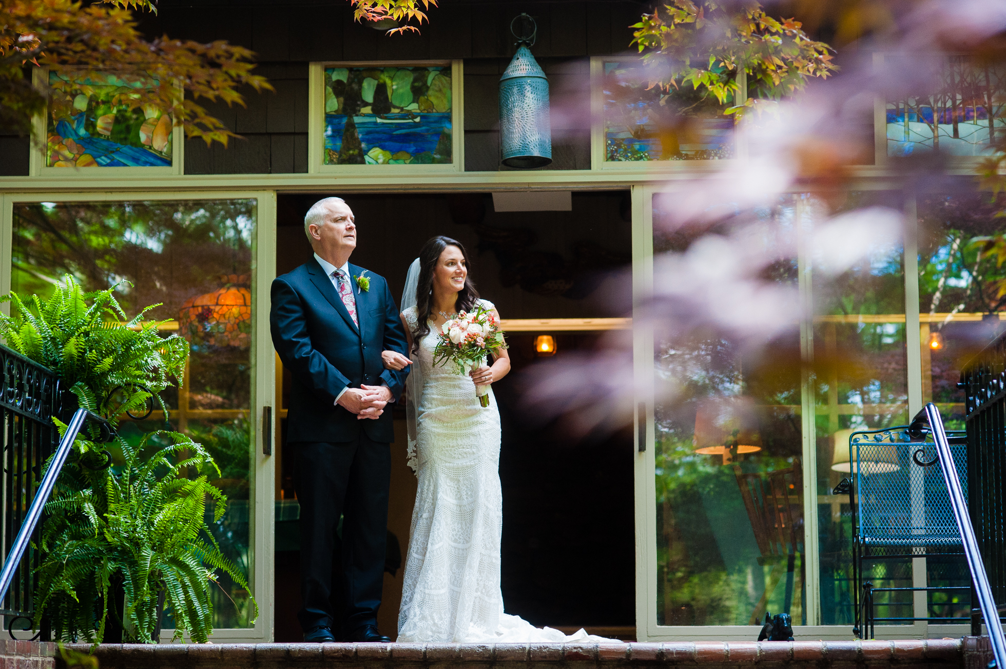 bride and groom watch ceremony from house