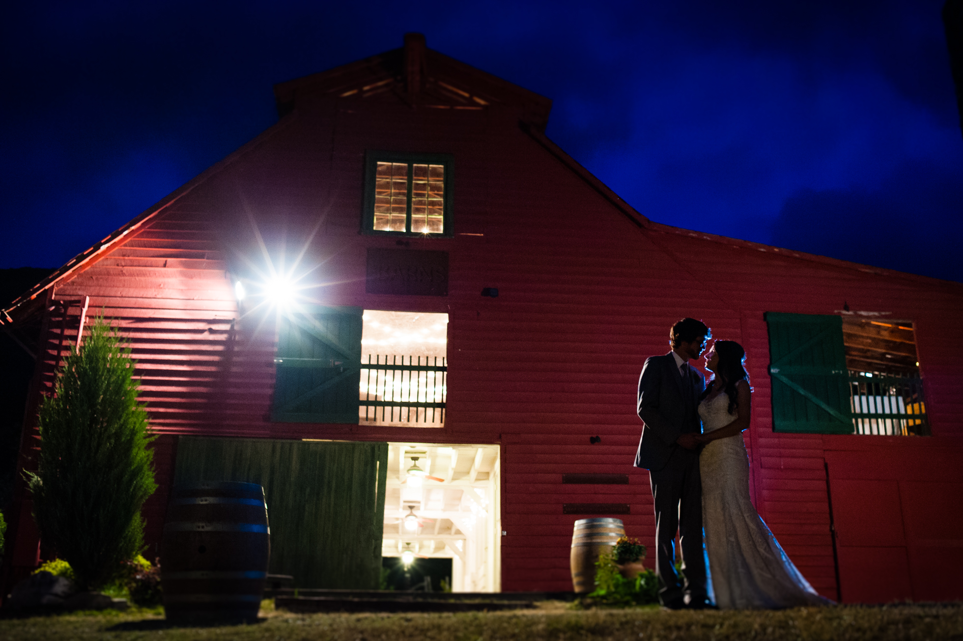 lake eden wedding barn at night with bride and groom 