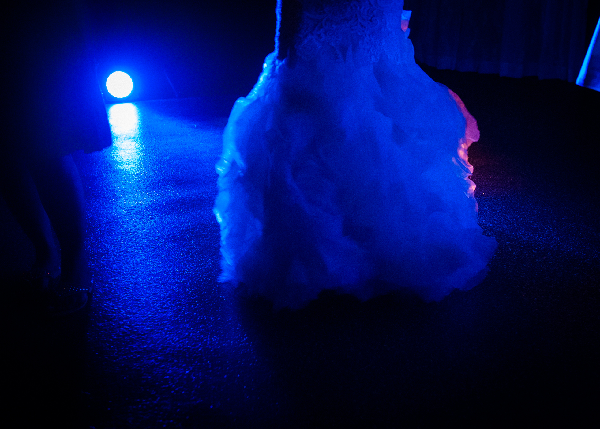 brides gown lit up on the dance floor