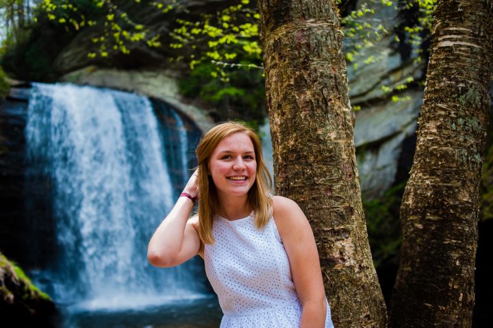 adventurous senior portraits by a waterfall