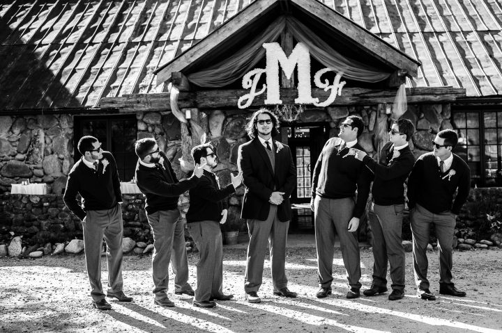 groomsmen in front of brown mountain beach resort 