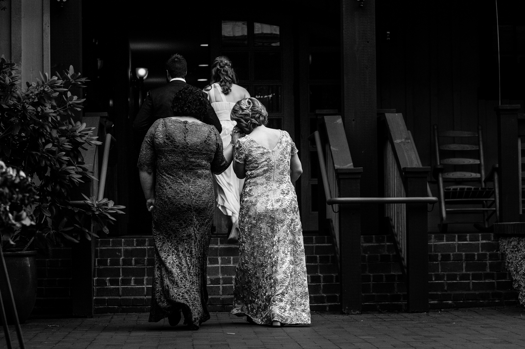 the two moms hold hands after their kids get married at lioncrest