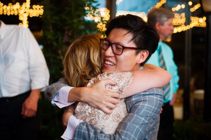 wedding guests hugging during wedding 