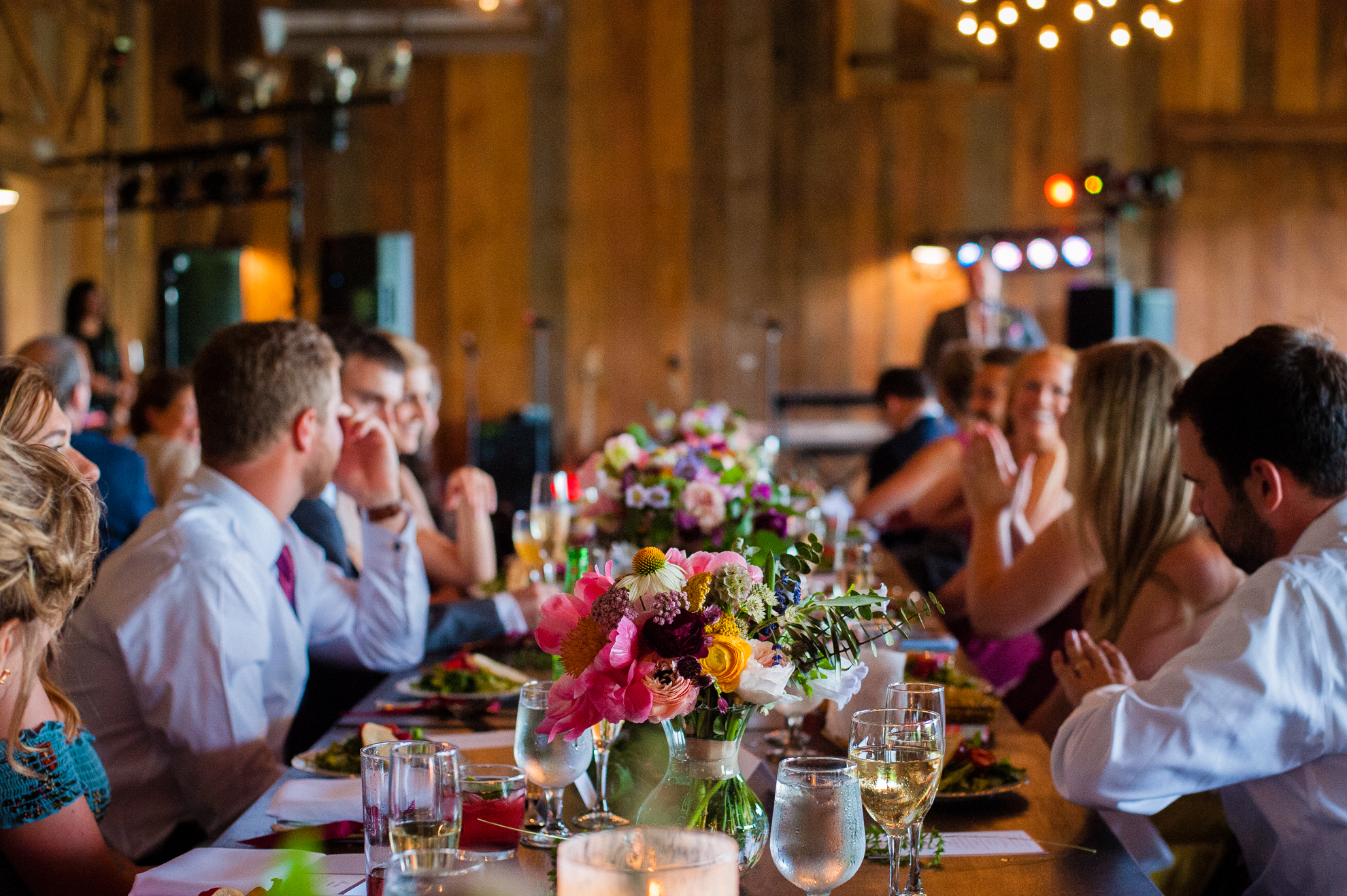 guests are seated at long wooden tables