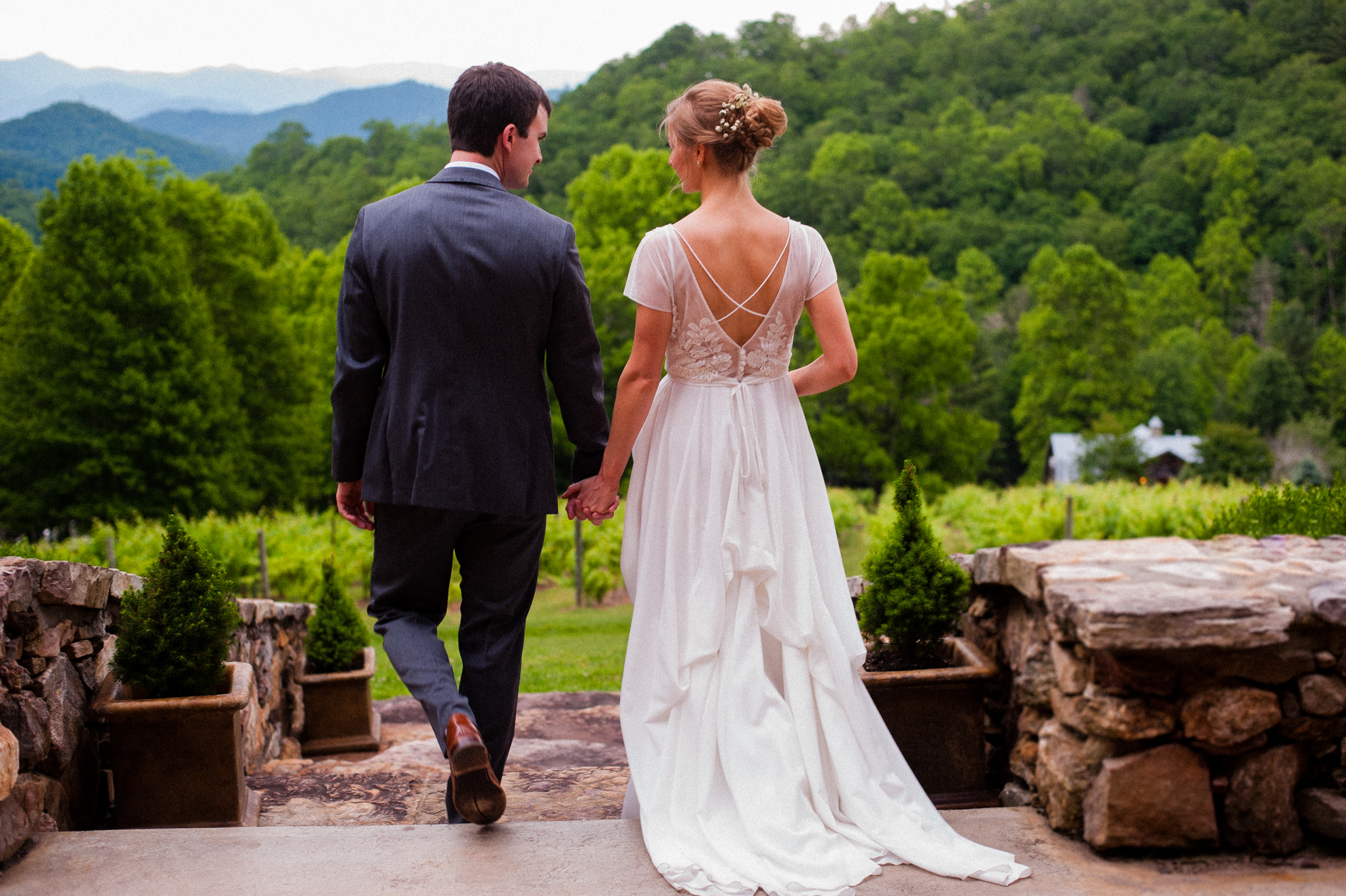 bride and groom hold hands outside the dunkard barn lodge 