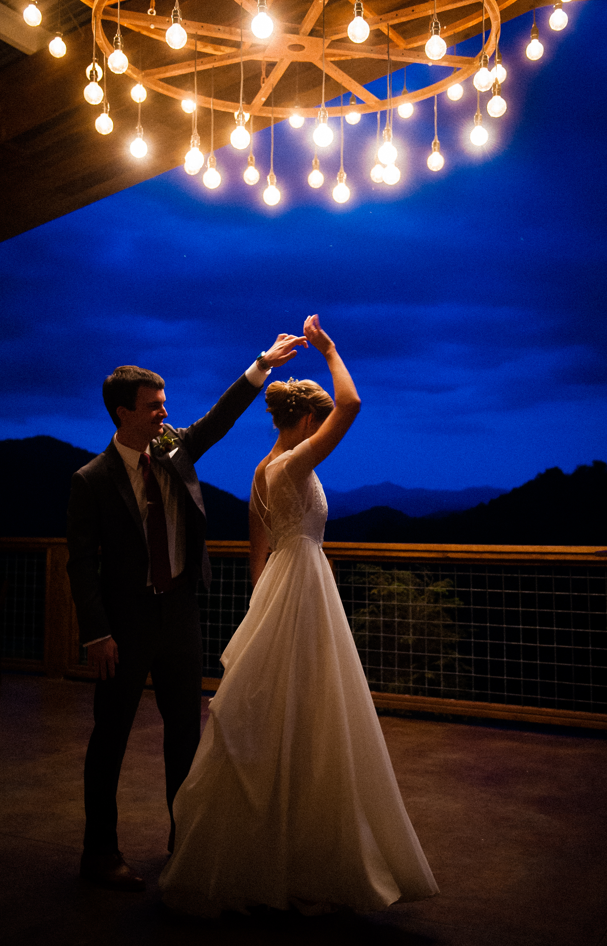 dancing under large chandelier at vineyards at bettys creek 