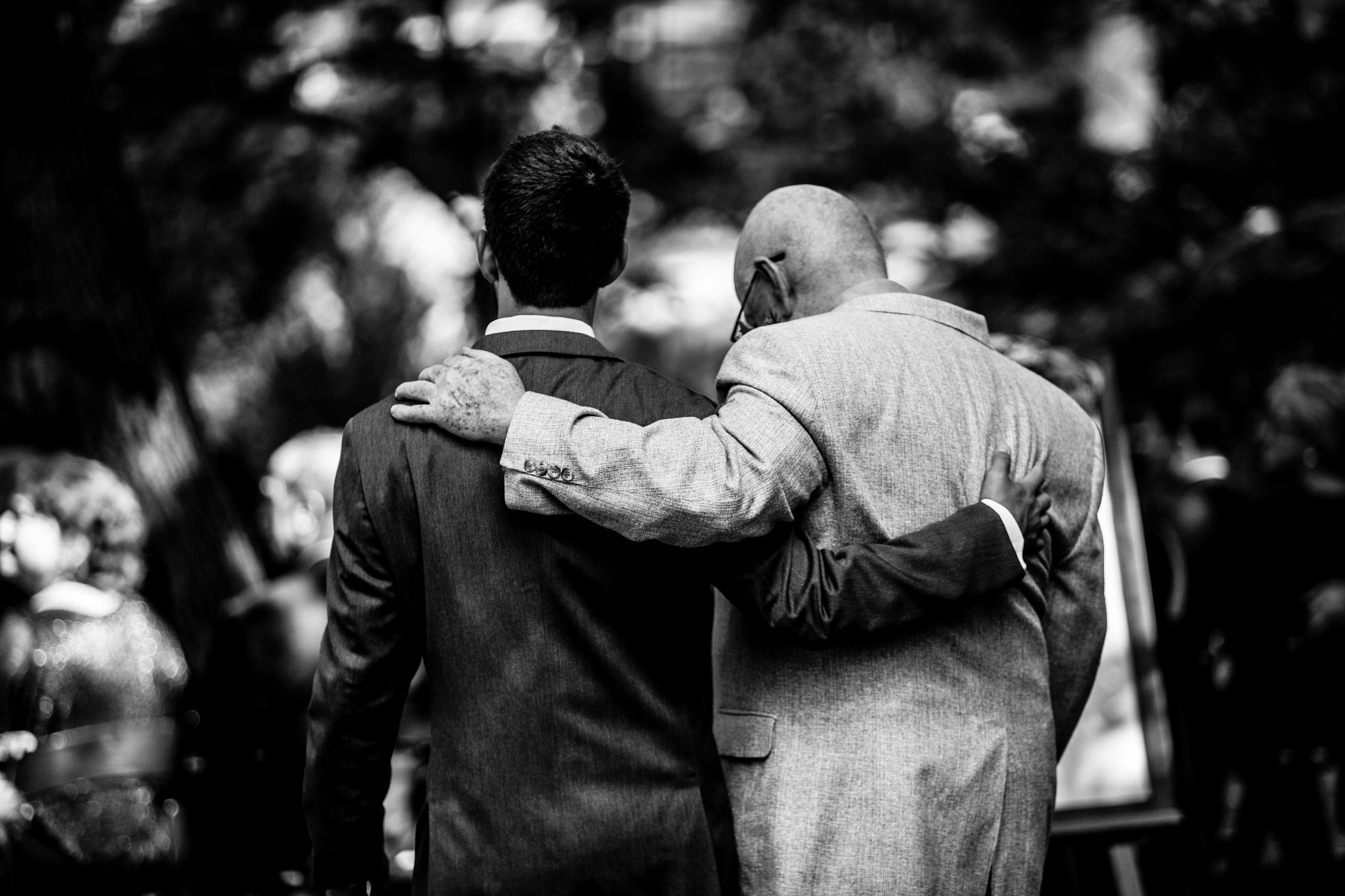 groom and his grandpa embrace before wedding ceremony 