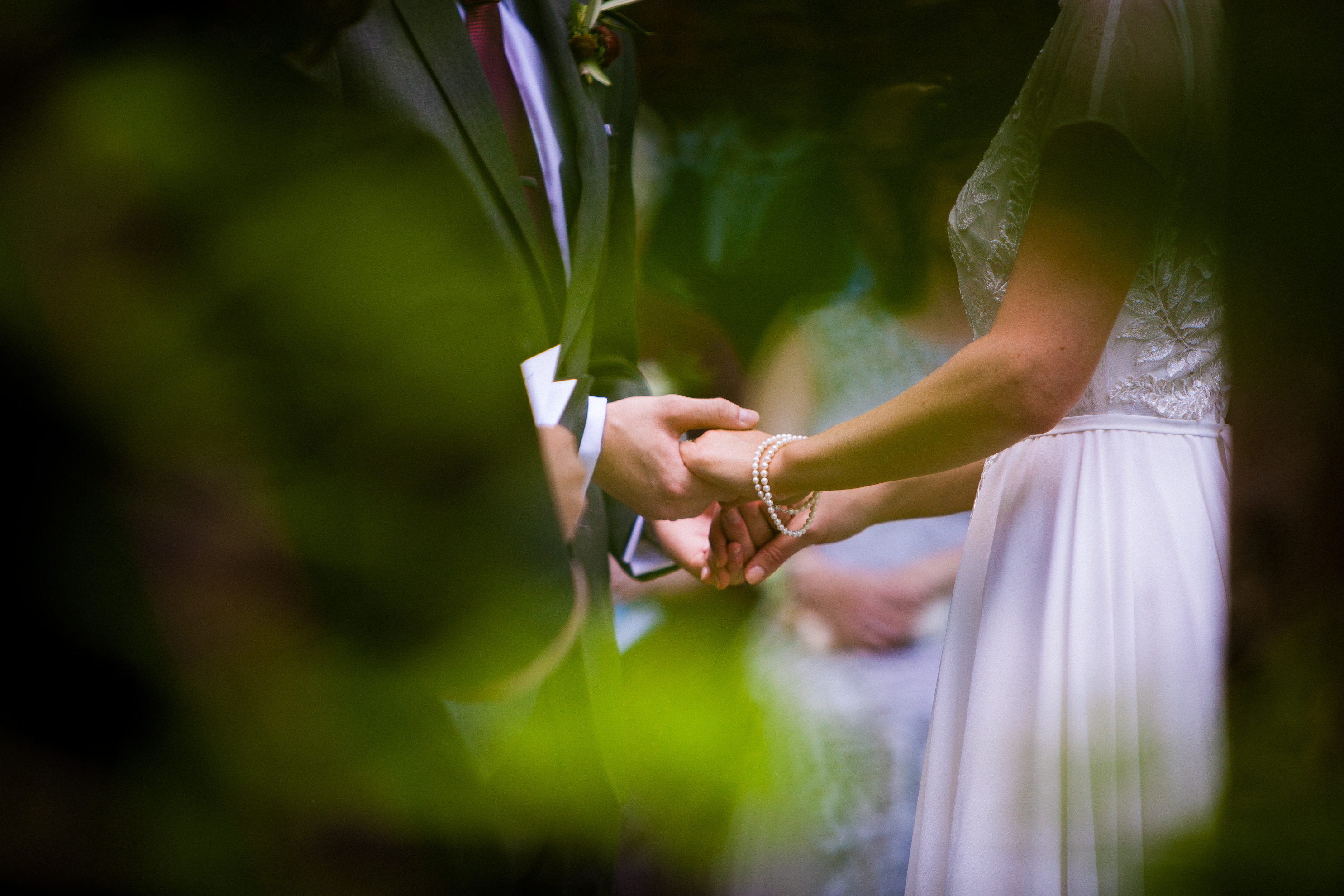 bride and groom hold hands during vineyards at bettys creek wedding 