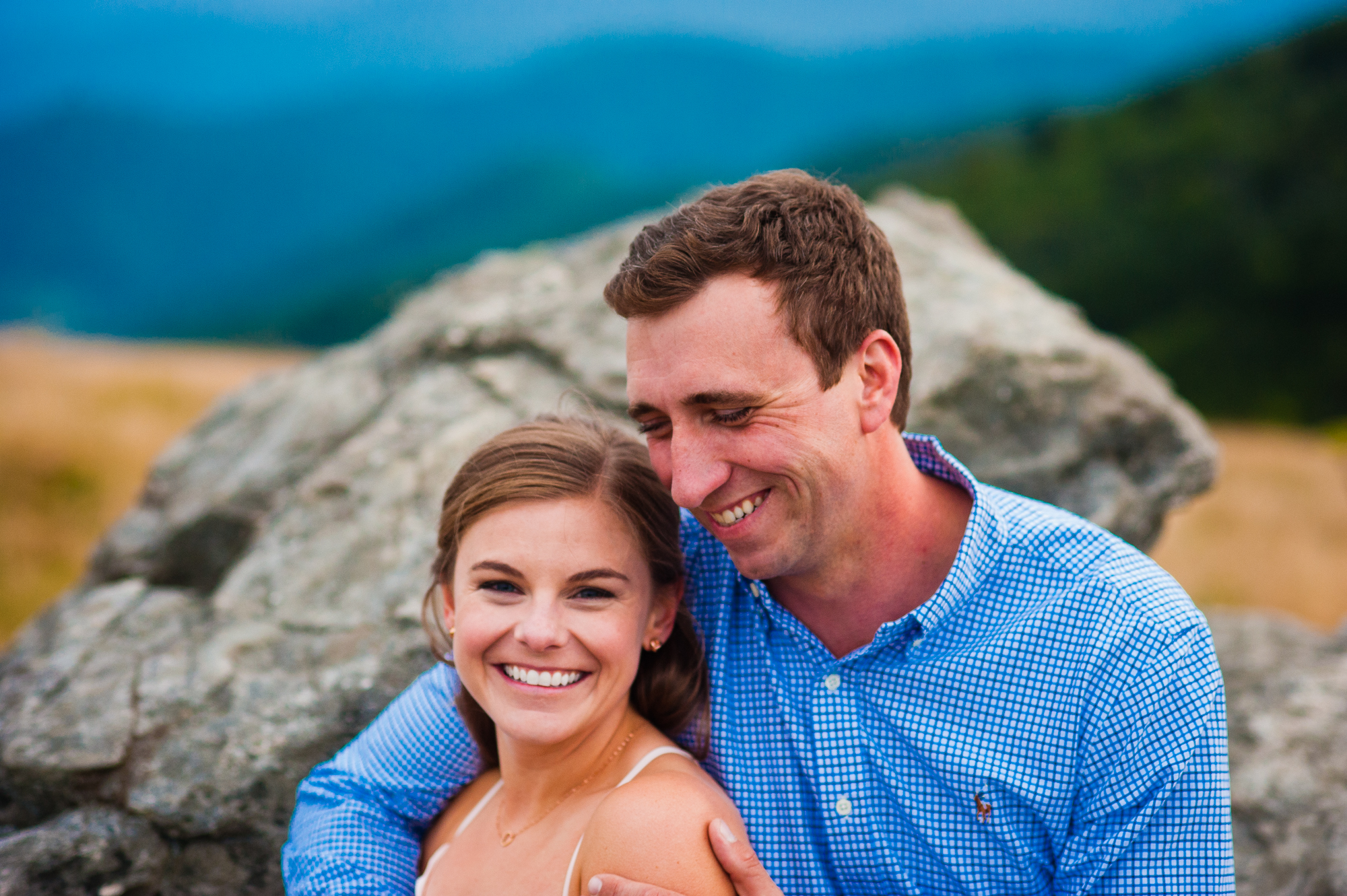 couple laughing during engagement session on roan mountain 