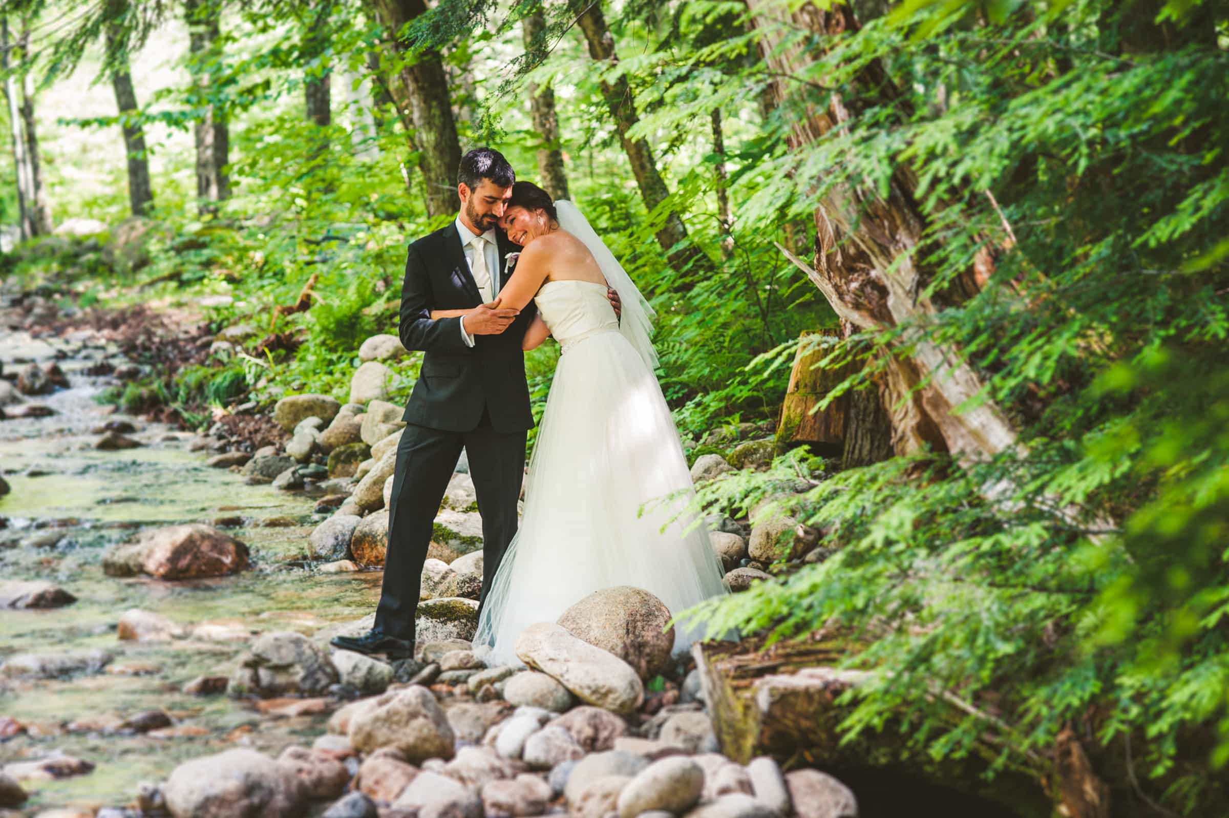 Couple embracing in a forest during their epic North Carolina elopement 