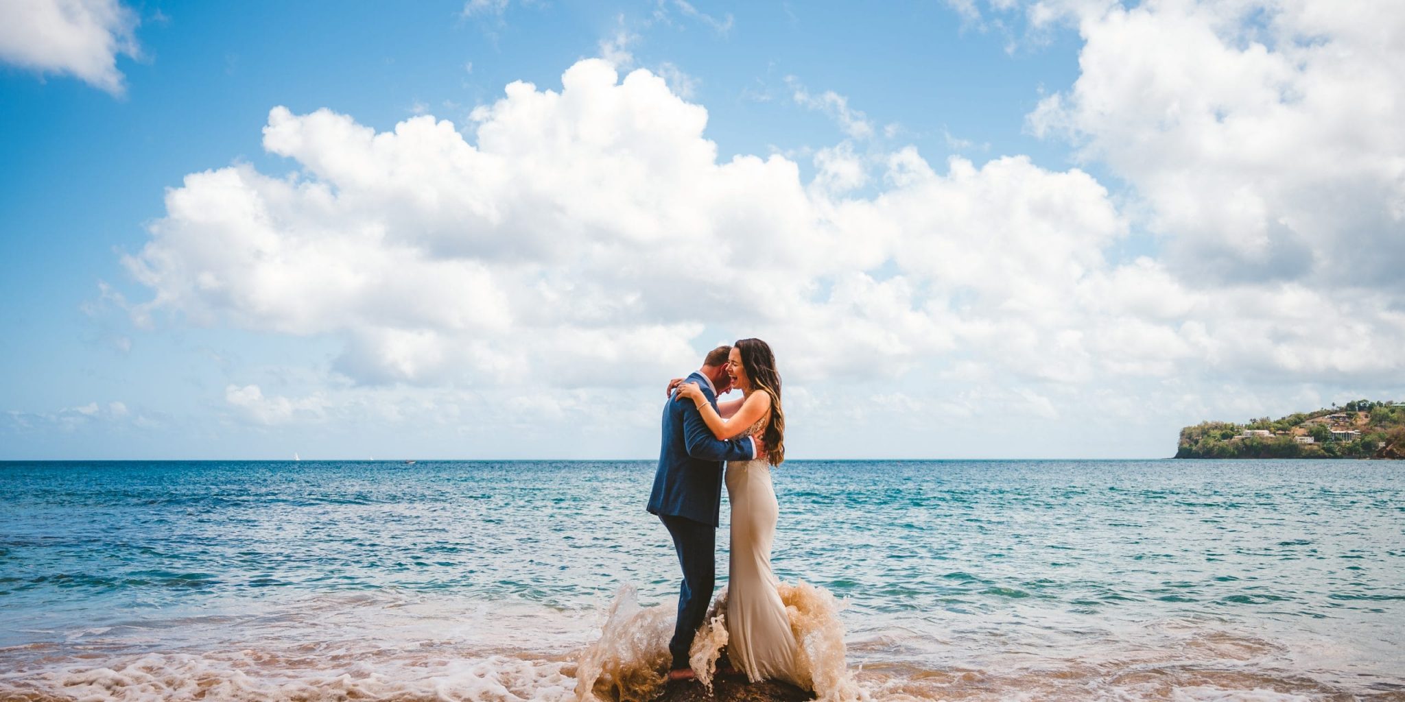 adventurous couple who eloped in Kauai playing in the ocean - Kauai Elopement Photographer