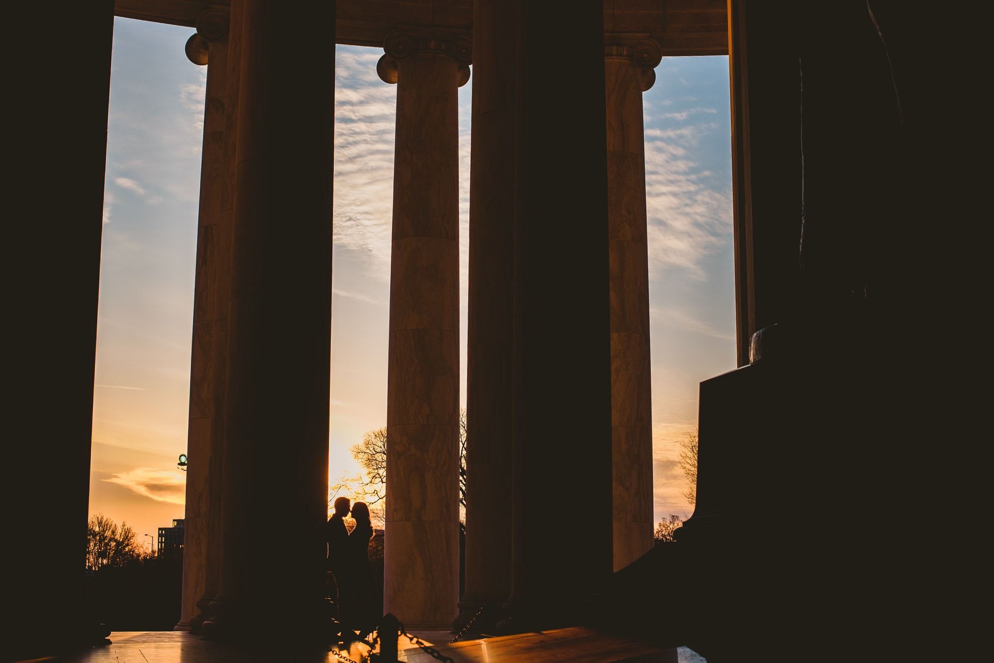 Sunrise silohuette of engaged couple at the Jefferson memorial in Washington DC