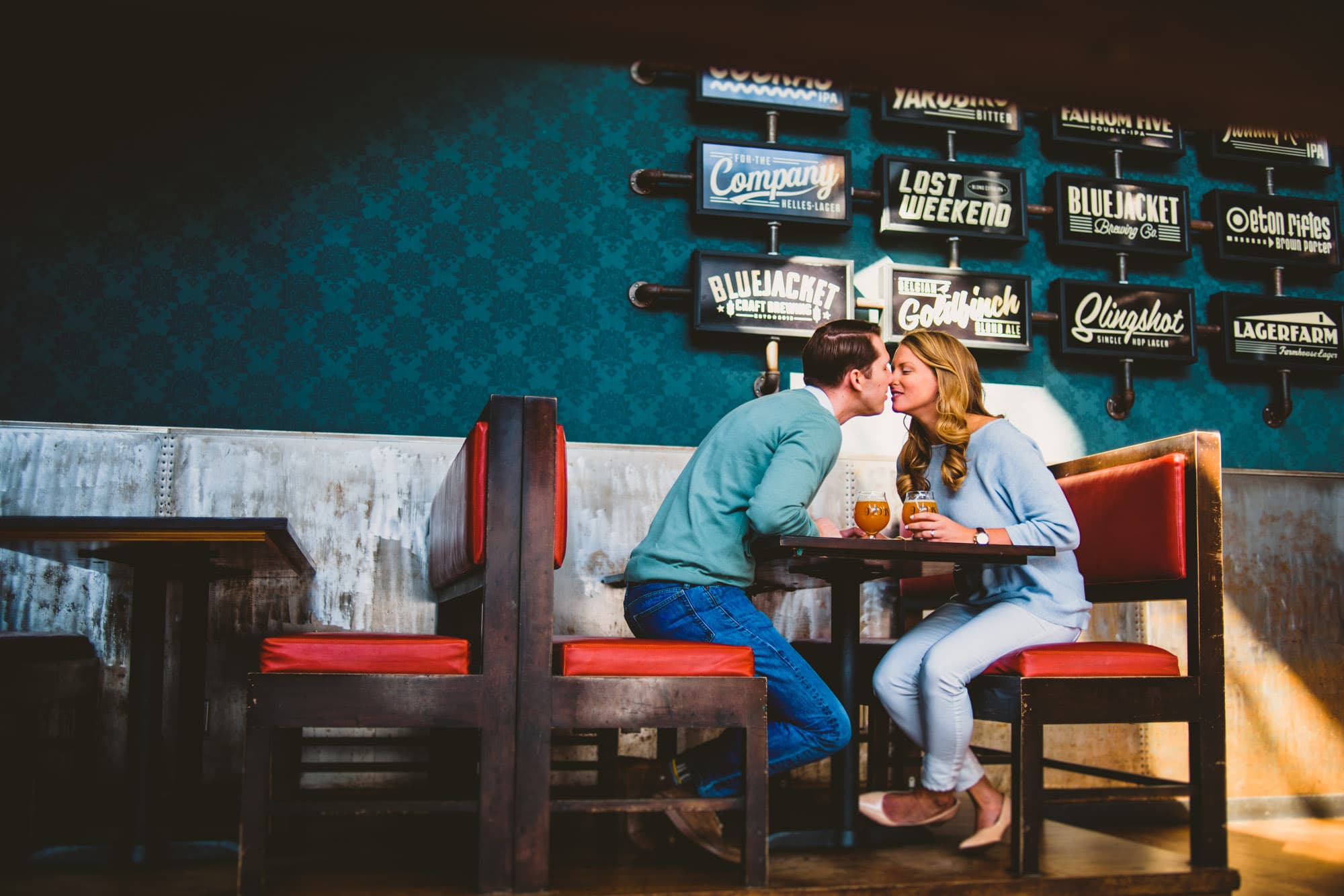 Couple sitting in a cute booth at a craft brewery