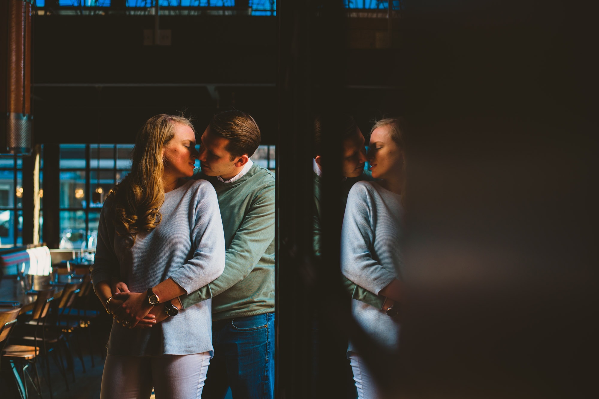 reflection of couple kissing during their engagement session at a washington dc brewery 