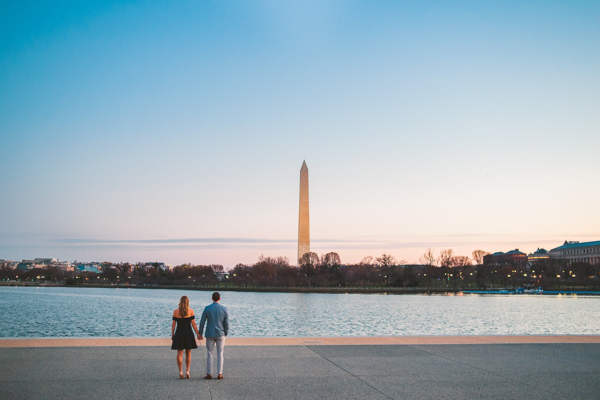 Early morning light with couple holding hands by the water