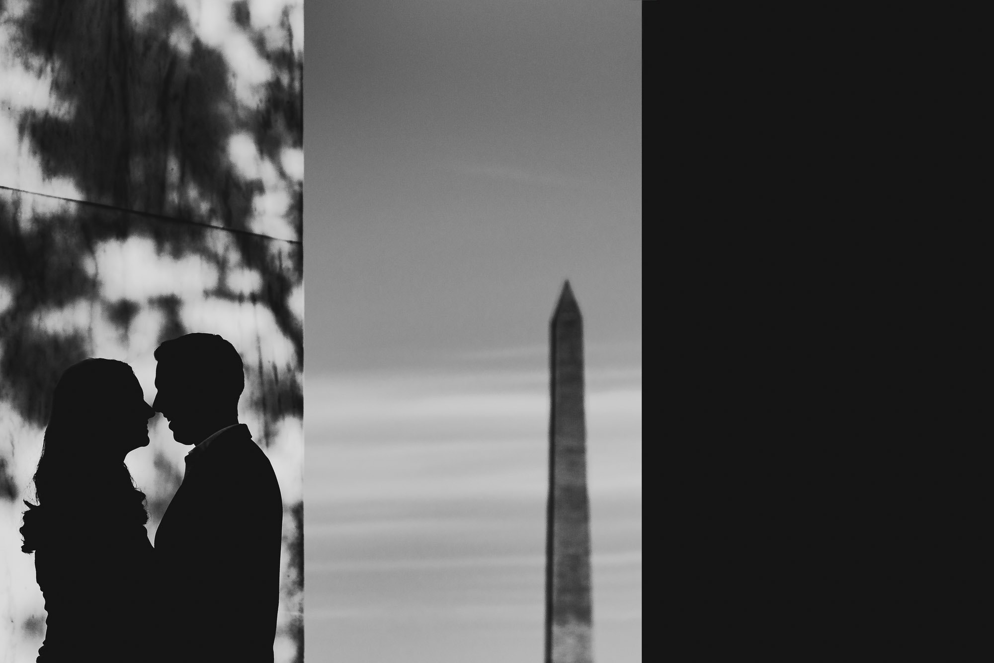 Dramatic black and white image silohuette of couple during their engagement session at the Jefferson Memorial