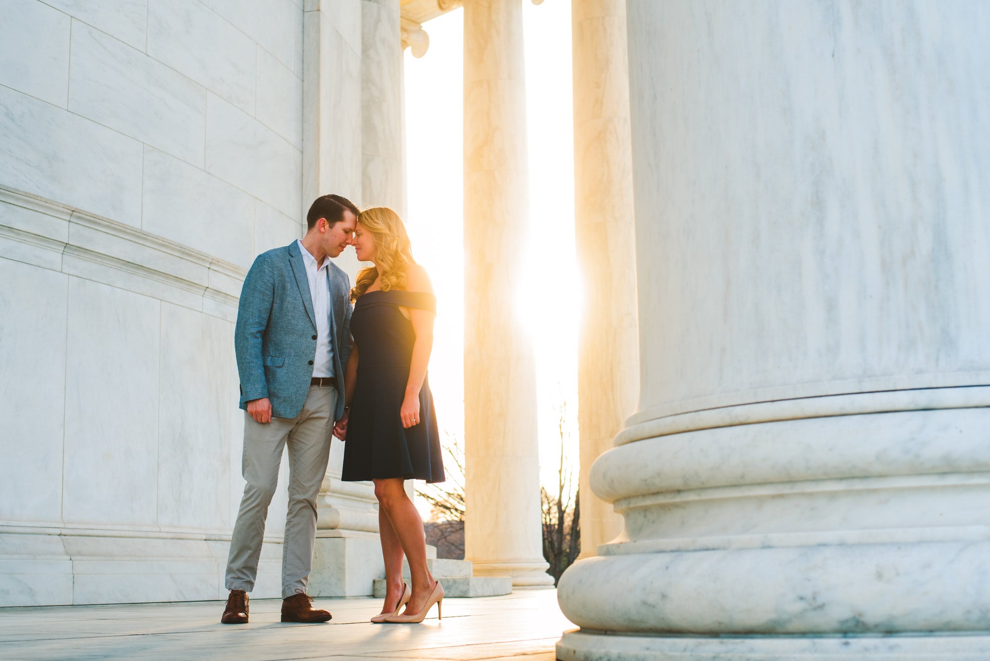 Sun peeking through the pillars at Jefferson Memorial during an engagement session. 