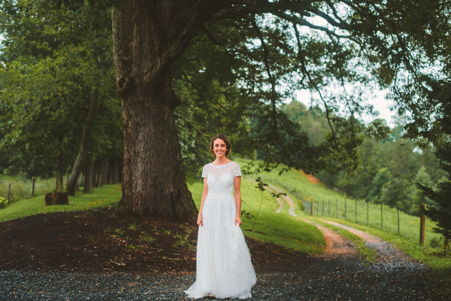 Bride on tree covered path at Yesterday Spaces a wedding venue near Asheville NC