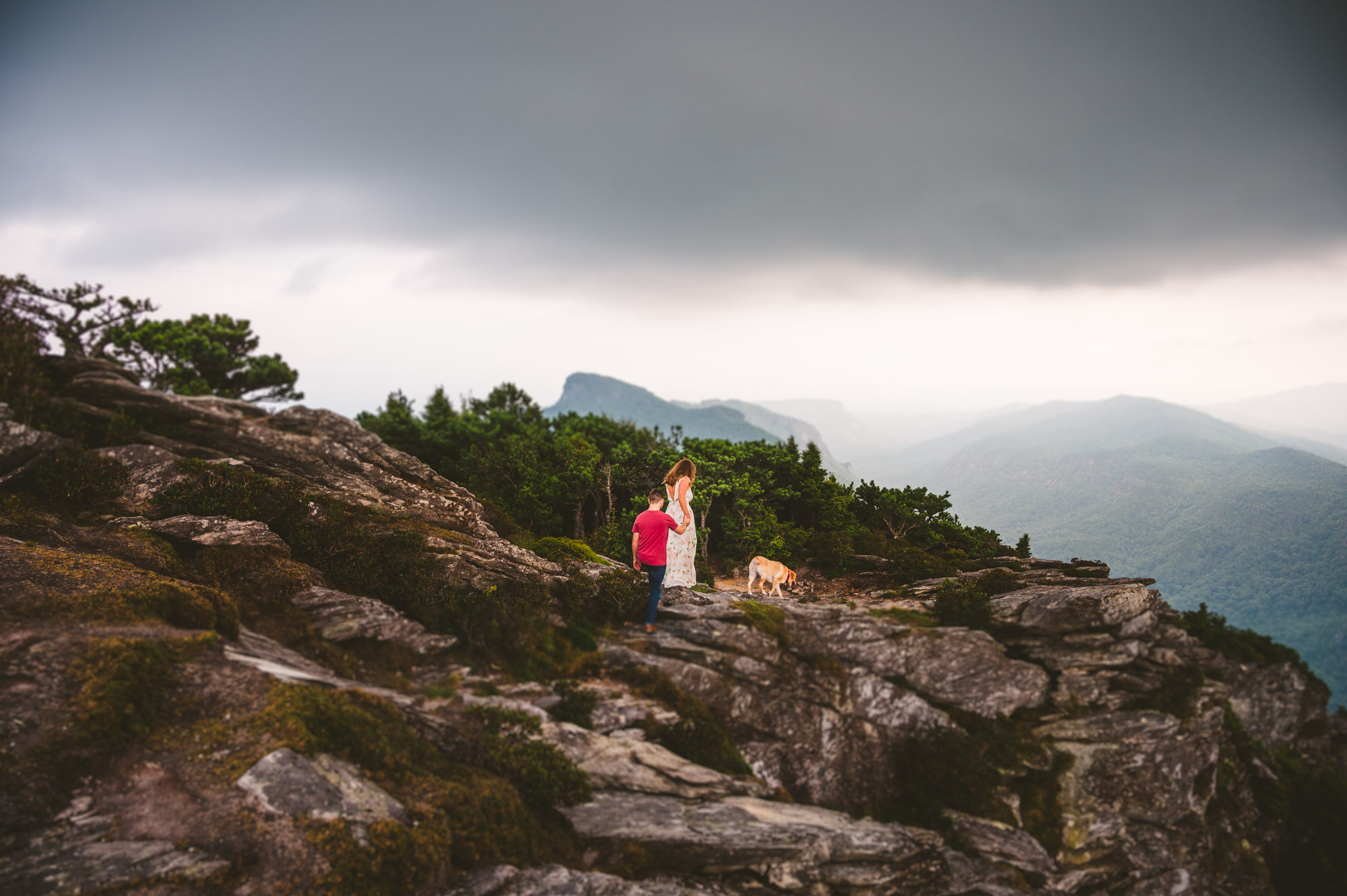 Couple hikes the side of Hawksbill Mountain during their Linville Gorge Engagement Session 