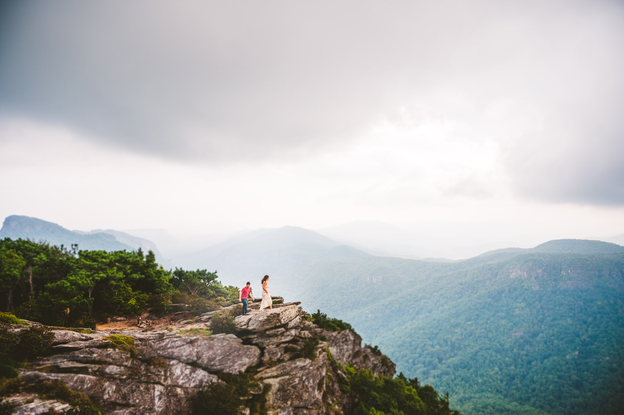 Couple exploring Linville Gorge Wilderness during adventure engagement session