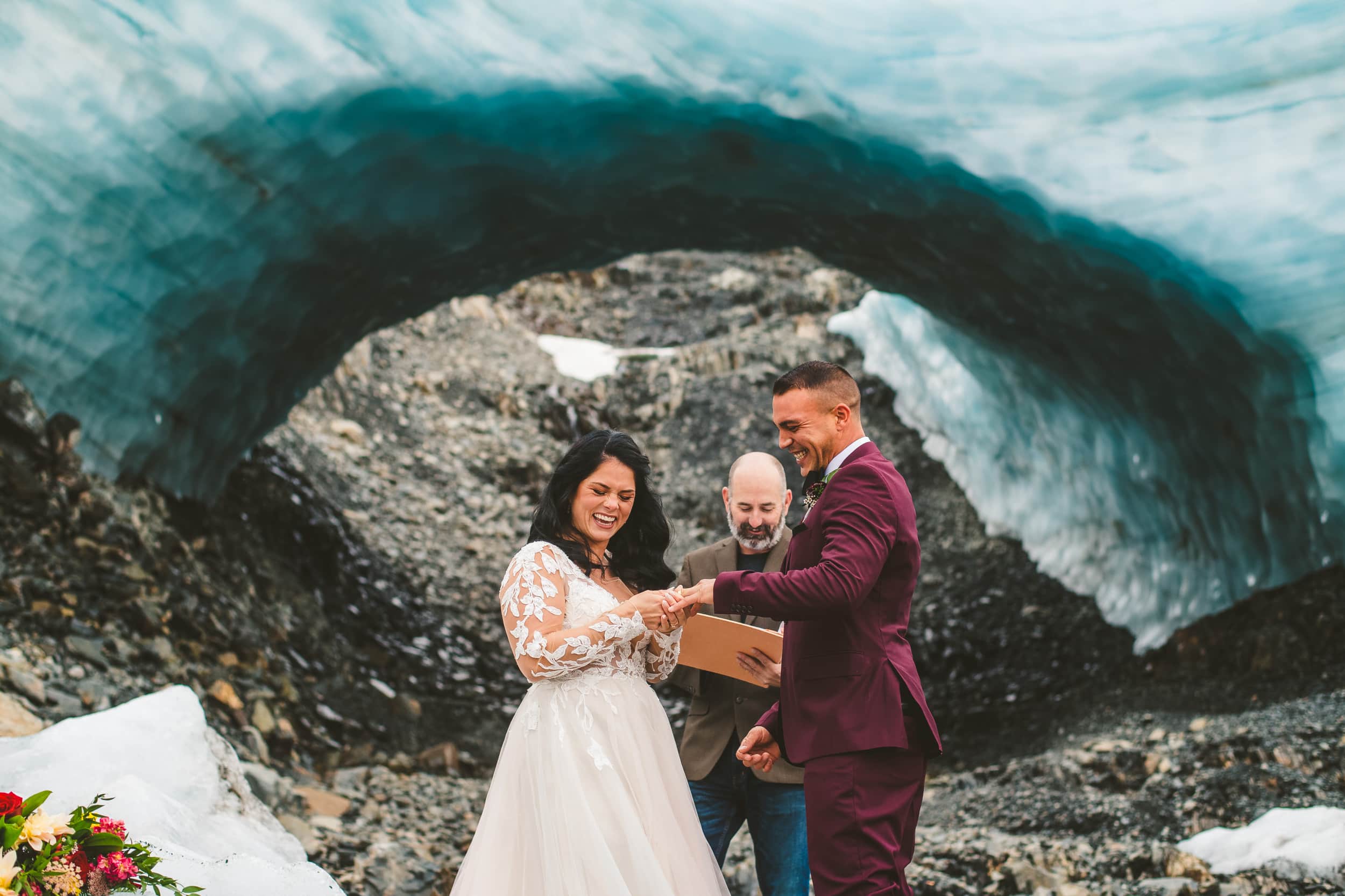 bride and groom exchange rings during seward glacier elopement 