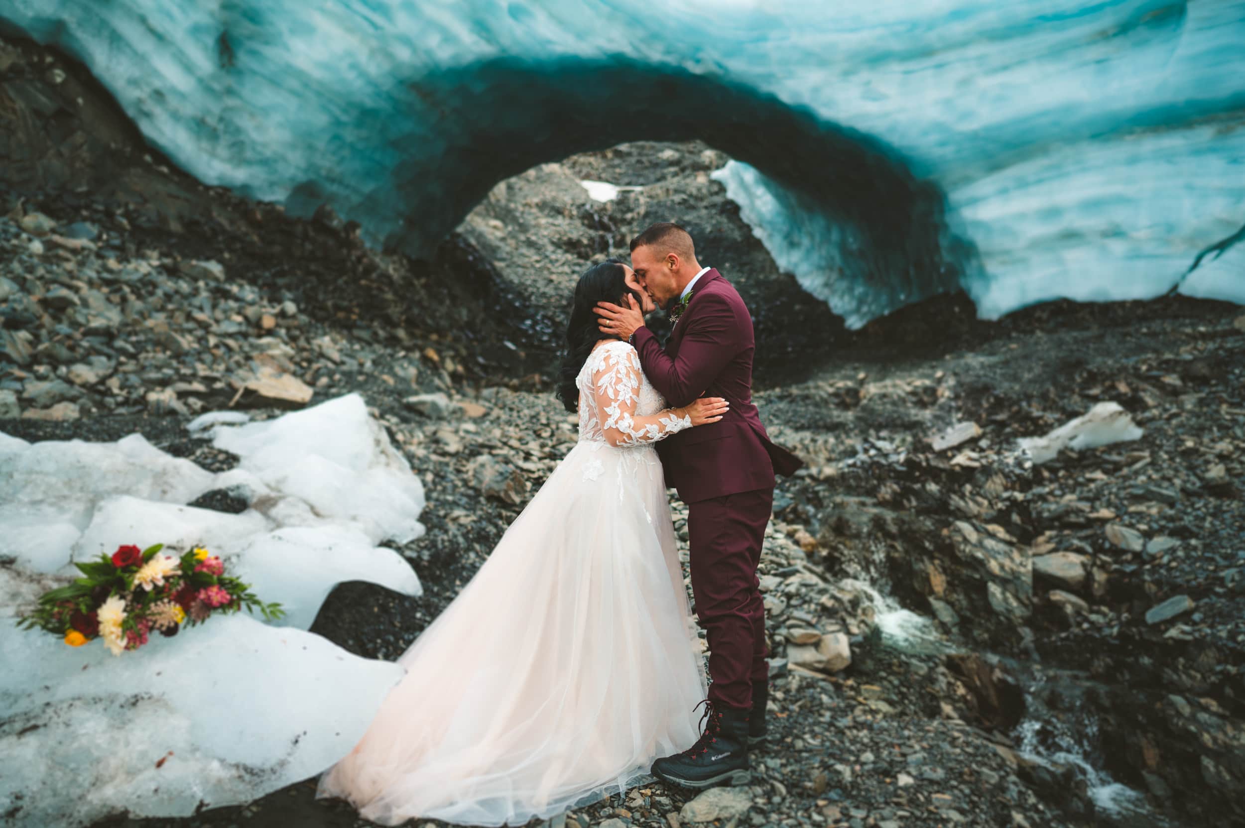 first kiss under glacier ice cave during alaska glacier elopement 