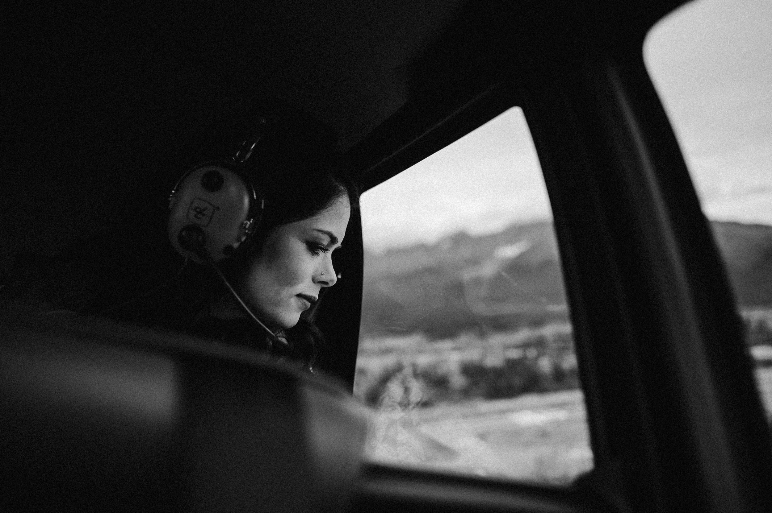 bride looking out of helicopter window mid flight